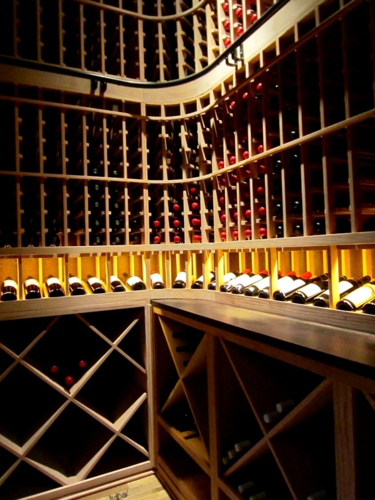 Wooden wine racks installed in a home wine cellar by Phoenix Builders